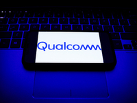 Qualcomm logo displayed on a phone screen and a laptop keyboard are seen in this illustration photo taken in Krakow, Poland on October 30, 2...