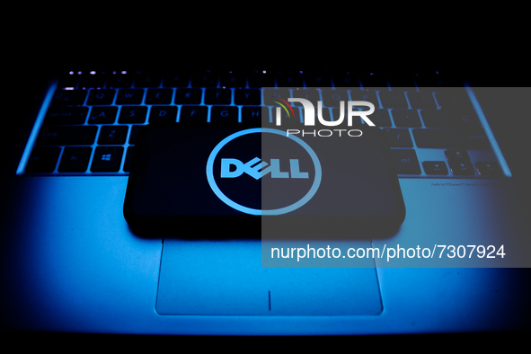 Dell logo displayed on a phone screen and a laptop keyboard are seen in this illustration photo taken in Krakow, Poland on October 30, 2021....