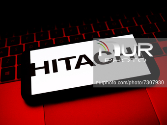 Hitachi logo displayed on a phone screen and a laptop keyboard are seen in this illustration photo taken in Krakow, Poland on October 30, 20...