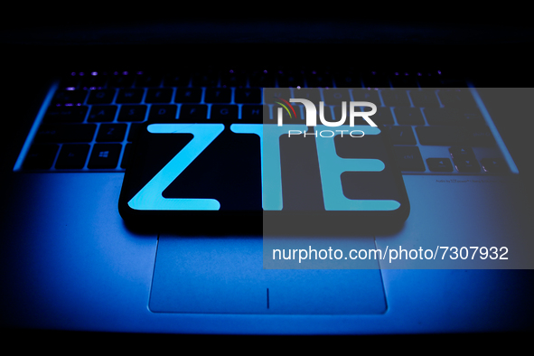 ZTE logo displayed on a phone screen and a laptop keyboard are seen in this illustration photo taken in Krakow, Poland on October 30, 2021. 
