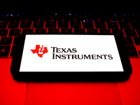 Texas Instruments logo displayed on a phone screen and a laptop keyboard are seen in this illustration photo taken in Krakow, Poland on Octo...