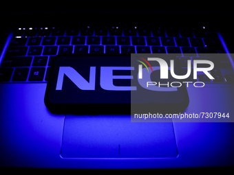NEC logo displayed on a phone screen and a laptop keyboard are seen in this illustration photo taken in Krakow, Poland on October 30, 2021....