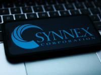 Synnex logo displayed on a phone screen and a laptop keyboard are seen in this illustration photo taken in Krakow, Poland on October 30, 202...