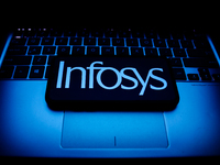 Infosys logo displayed on a phone screen and a laptop keyboard are seen in this illustration photo taken in Krakow, Poland on October 30, 20...