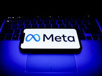Meta logo displayed on a phone screen and a laptop keyboard are seen in this illustration photo taken in Krakow, Poland on October 31, 2021....