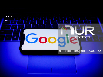 Google logo displayed on a phone screen and a laptop keyboard are seen in this illustration photo taken in Krakow, Poland on October 31, 202...