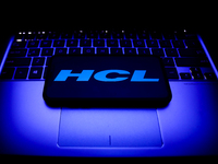 HCL logo displayed on a phone screen and a laptop keyboard are seen in this illustration photo taken in Krakow, Poland on October 31, 2021....