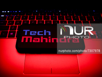Tech Mahindra logo displayed on a phone screen and a laptop keyboard are seen in this illustration photo taken in Krakow, Poland on October...