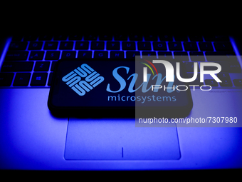 Sun Microsystems logo displayed on a phone screen and a laptop keyboard are seen in this illustration photo taken in Krakow, Poland on Octob...