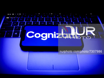 Cognizant logo displayed on a phone screen and a laptop keyboard are seen in this illustration photo taken in Krakow, Poland on October 31,...