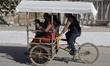 A family aboard a tricycle in the streets of the indigenous Mayan community of Pomuch, loc...