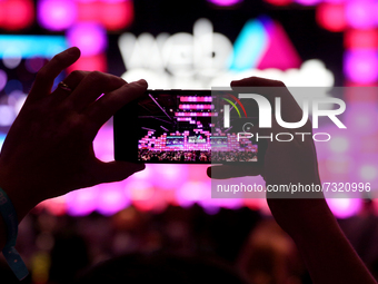 An attendee takes a smartphone picture on the opening day of the 2021 Web Summit in Lisbon, Portugal on November 1, 2021. The Web Summit 202...