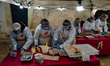Elderly women prepare typical bread during the Sagra de 'la quartecèdde on the occasion of...