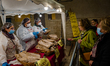 Elderly women explain to people how the typical bread is stuffed during the Sagra de 'la q...