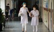 Medical professionals seen at the hall way of a local school where it has turned to be a t...