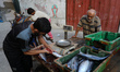 Palestinians surround a horse cart at al-Shati refugee camp in Gaza City, on November 10,...