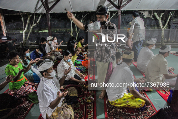 Hindu-Balinese people receive blessings as their offering prayers during the Galungan Hindu festival at Pura Agung Raksa Buana on November 1...