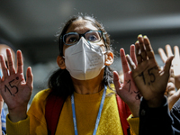 Young activists protest in the COP26 venue - Scottish Event Campus during the eleventh day of the COP26 UN Climate Change Conference, held b...