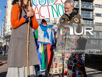People protest in front of the COP26 venue - Scottish Event Campus during the eleventh day of the COP26 UN Climate Change Conference, held b...