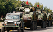 Armoured vehicles are deployed during a shore defense operation as part of a military exer...