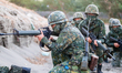 Taiwanese Soldiers with guns in position during a shore defense operation as part of a mil...
