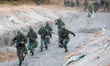 Taiwanese Soldiers with guns rush to a fort, during a shore defense operation as part of a...