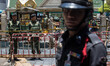 Army soldiers and a policeman stand guard front of the Erawan Shrine,
as we can see the d...