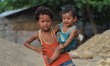 An Indian kid hold her sibling as their parent work at a temporary stone quarry in Dimapur...