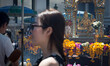 A woman having an interview for the media with the Erawan statue in the back side, at the...