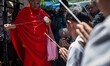 A monk having a religious song as people pray front of the reopened Erawan Shrine in Centr...