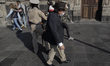 An older adult wearing a sombrero near the Zócalo in Mexico City during the COVID-19 healt...