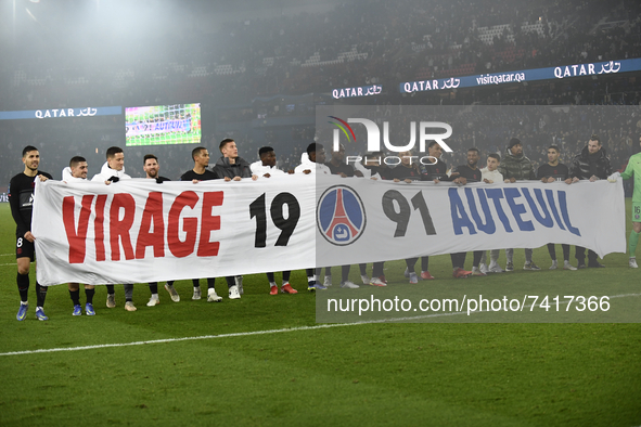 PSG´s players hold a banner to mark the 30th anniversary of the "Virage Auteuil" PSG group of supporters after the Ligue 1 Uber Eats match b...