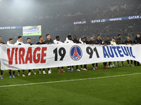 PSG´s players hold a banner to mark the 30th anniversary of the "Virage Auteuil" PSG group of supporters after the Ligue 1 Uber Eats match b...