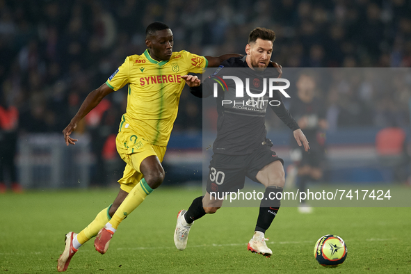 Leo Messi of and  n42 compete for the ball during the Ligue 1 Uber Eats match between Paris Saint Germain and FC Nantes at Parc des Princes...