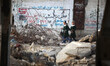 Palestinian schoolgirls walk inside their school that was destroyed during the 50-day war...