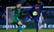 Mickael Ramon Malsa (R) of Levante UD competes for the ball with Kike Barja of CA Osasuna...