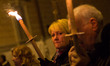 People participate in a candle rally in L'Aquila on April 6, 2014 to commemorate the fifth...