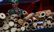 Official stands guard next to a pile of illegal ivory during a campaign to destroy over 2...
