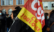 A woman holds a flag of the CGT CAF union. All trade unions from the Social Security, the...