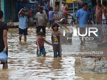Two Indian kids wade through flooded street after heavy downpour in Dimapur, India north eastern state of Nagaland on Thursday, August 27, 2...
