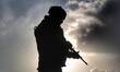 An Indian army soldier keeps vigil as he stands alert in Shopian, Jammu and Kashmir, India...
