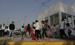 A human rights observer plays with children from the Central American migrant caravan in t...