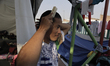 A member of the migrant caravan shapes his hair inside the facilities of the Casa Peregrin...