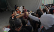 Central American migrants receive donations of clothing at the Casa Peregrino facilities i...