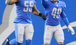 Detroit Lions inside linebacker Derrick Barnes (55) and Detroit Lions running back Craig R...