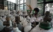 A worker cleans empty oxygen cylinders at a COVID care centre set up to fight the newer 'o...