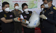 Thai Director-General of Customs, Patchara Anuntasilpa (R) displays items from seized crys...