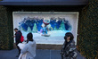 Pedestrians view the holiday windows at the Macy's Inc. flagship department store in the H...