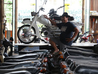 Visitors see a row of old motorcycles for purchase and replacement of antique motorcycle parts that are being restored at the old Motorcycle...