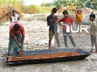 Workers making Gur (jaggery) in a village on December 10, 2021 in Barpeta, Assam, India. Gur (jaggery) is a natural product of sugarcane, ma...